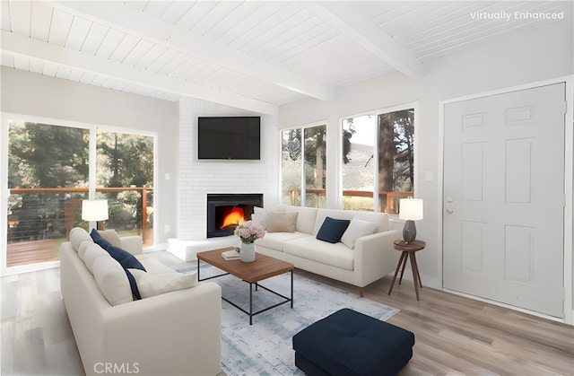 living room with beamed ceiling, a large fireplace, wooden ceiling, and light wood-type flooring