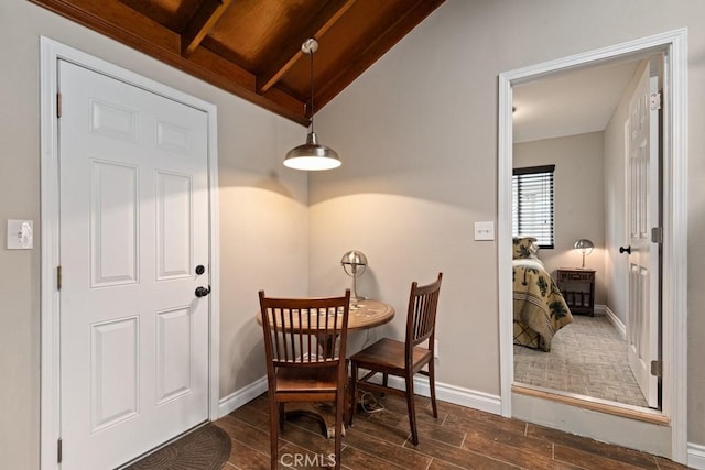 dining area with wood ceiling and lofted ceiling with beams