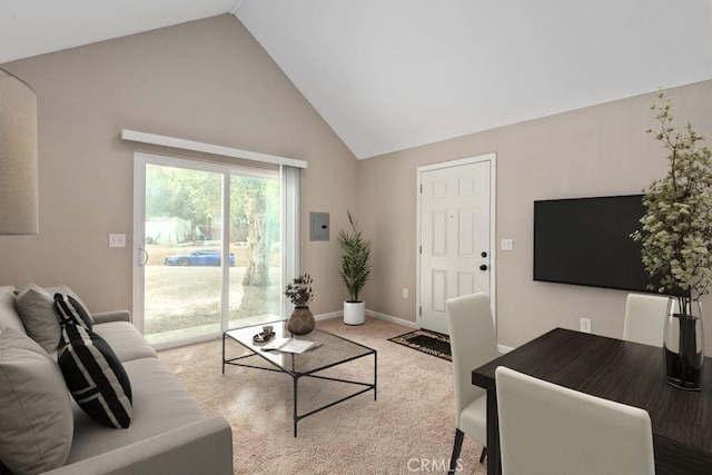 living room featuring high vaulted ceiling and carpet flooring