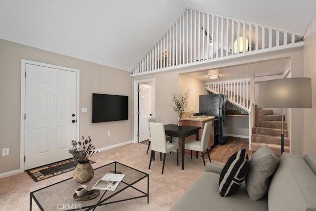 living room featuring carpet floors and high vaulted ceiling