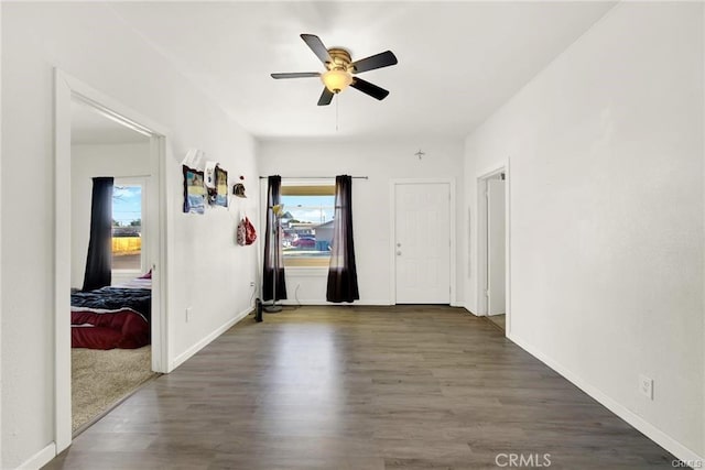 spare room with ceiling fan and dark hardwood / wood-style flooring