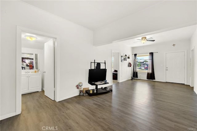 living room with ceiling fan and dark hardwood / wood-style flooring