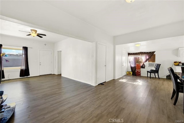 living room with ceiling fan, dark wood-type flooring, and a healthy amount of sunlight