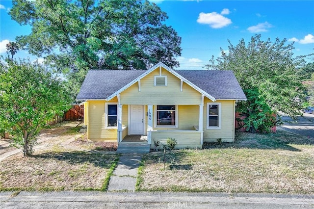 bungalow-style house with a front lawn