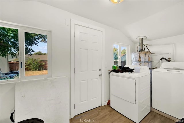 laundry area featuring hardwood / wood-style floors and washing machine and clothes dryer