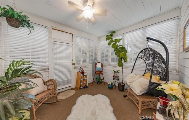 carpeted bedroom featuring ceiling fan, wood ceiling, and wooden walls