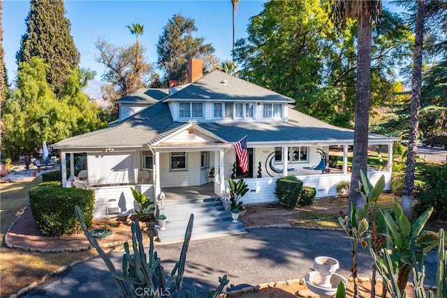 view of front of house featuring a porch and a carport