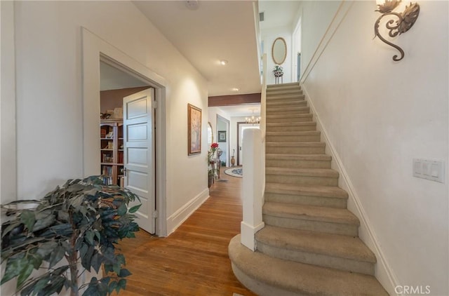 stairs featuring hardwood / wood-style flooring