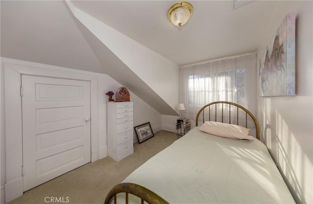 carpeted bedroom with lofted ceiling