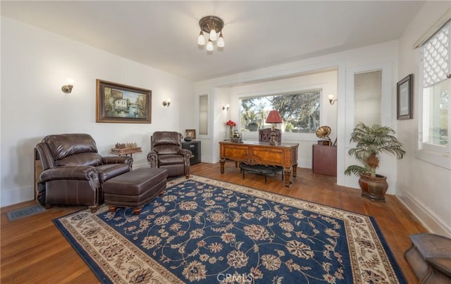 sitting room with wood-type flooring