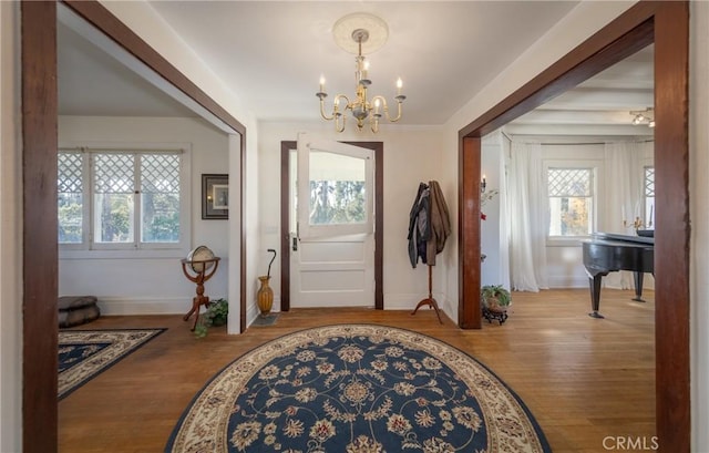 foyer with a chandelier and hardwood / wood-style flooring