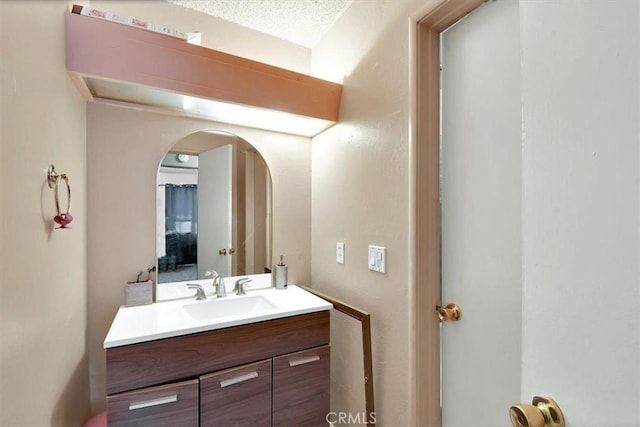 bathroom with a textured ceiling and vanity