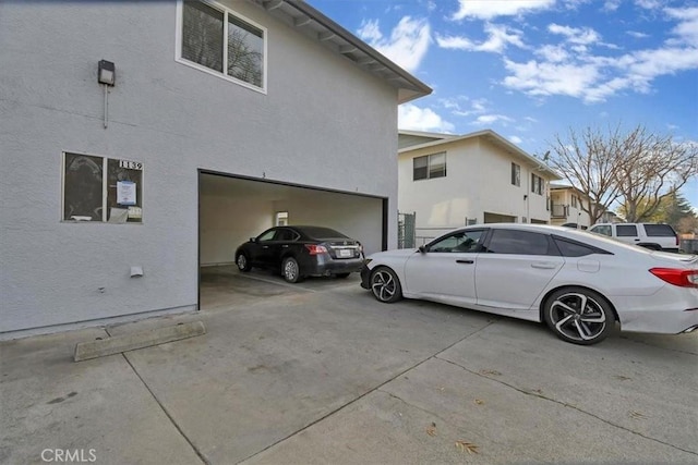 view of home's exterior with an attached garage and stucco siding