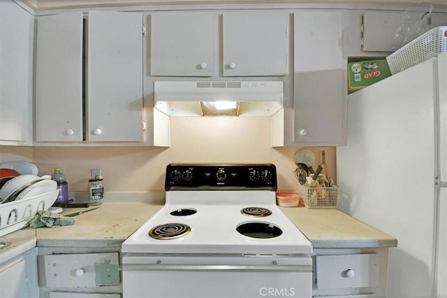 kitchen with white cabinets, under cabinet range hood, white appliances, and light countertops