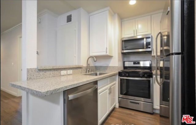 kitchen featuring sink, white cabinets, dark wood-type flooring, and appliances with stainless steel finishes