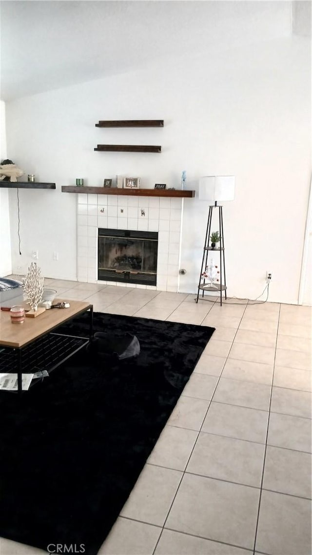 tiled living room featuring a tiled fireplace