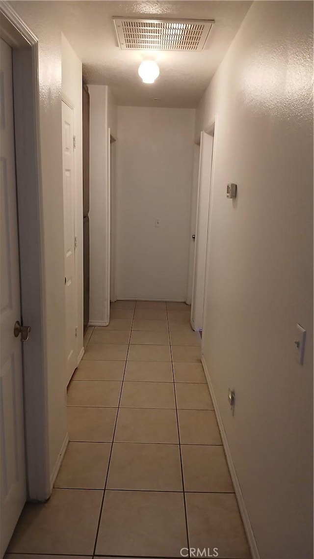 hallway with light tile patterned flooring