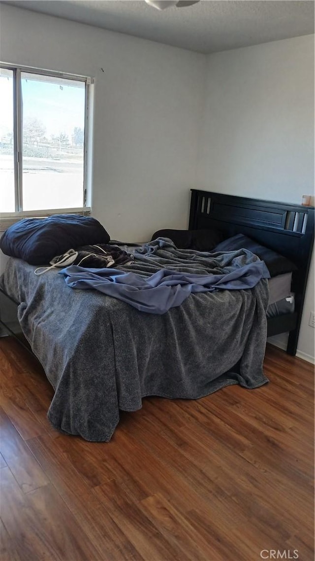 bedroom featuring dark wood-type flooring