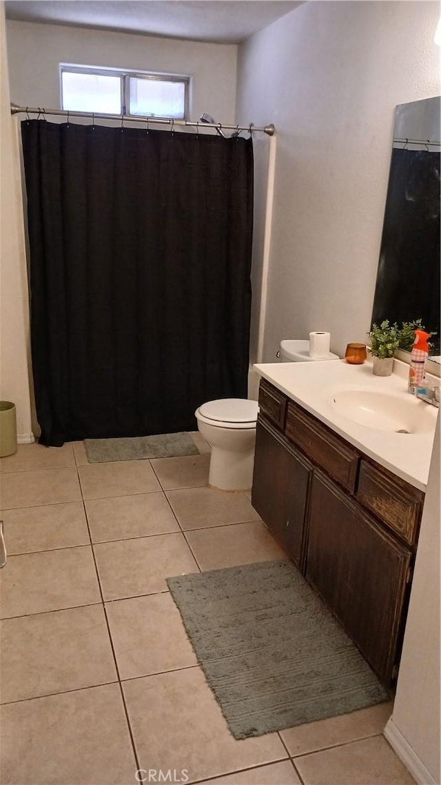 bathroom featuring toilet, vanity, and tile patterned floors