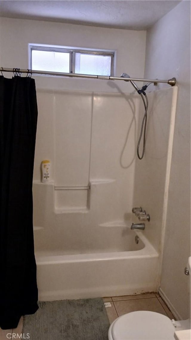 bathroom with toilet, shower / tub combo, and tile patterned floors