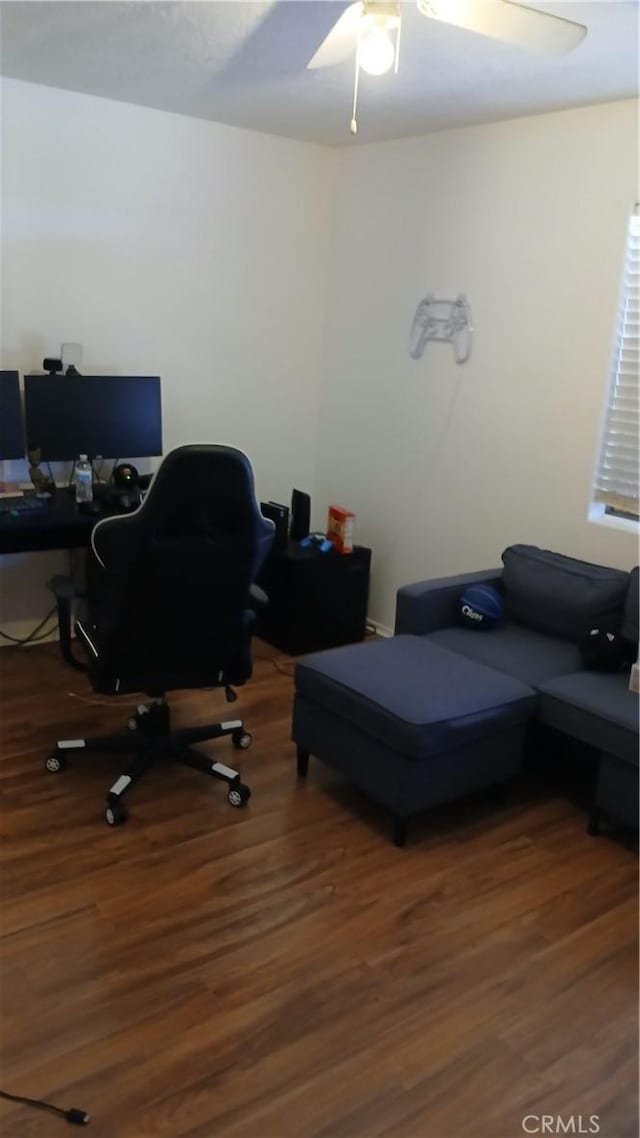 home office with ceiling fan and dark wood-type flooring