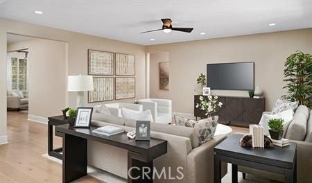 living room featuring light hardwood / wood-style flooring and ceiling fan