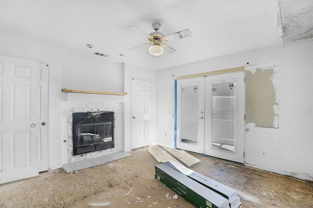 unfurnished living room with ceiling fan