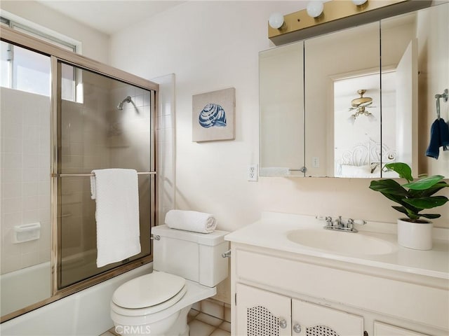 full bathroom with tile patterned flooring, vanity, toilet, and combined bath / shower with glass door