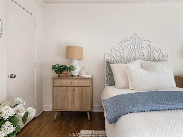 bedroom with dark wood-type flooring and ornamental molding