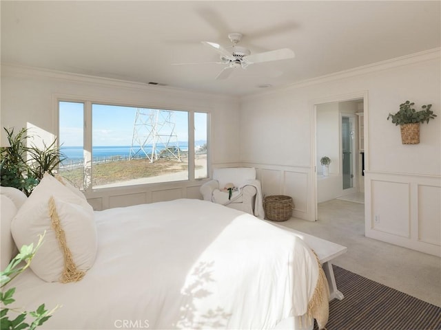 bedroom with ceiling fan, a water view, light colored carpet, and crown molding