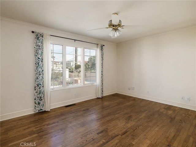 spare room featuring dark hardwood / wood-style floors, ceiling fan, and crown molding