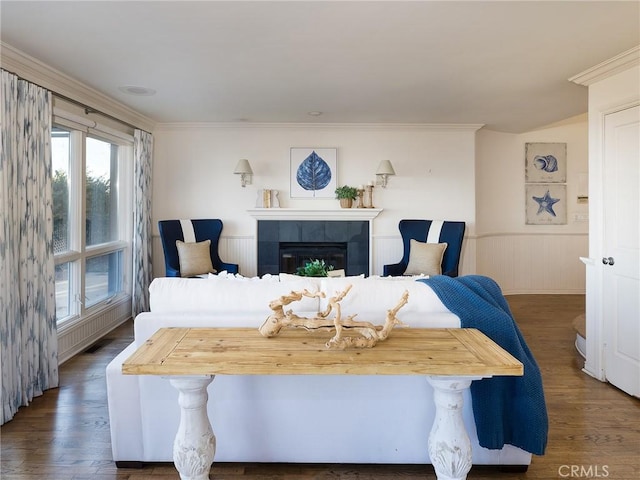 bedroom featuring crown molding, a fireplace, and dark wood-type flooring