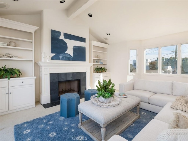 carpeted living room featuring vaulted ceiling with beams and a tiled fireplace