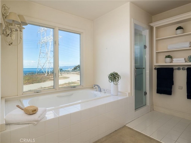 bathroom featuring tile patterned floors and tiled tub