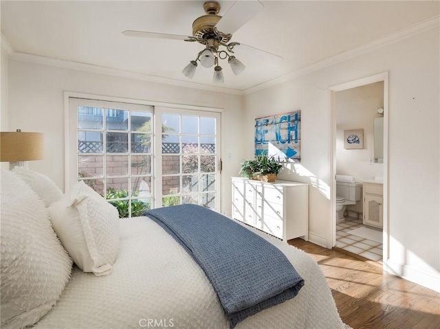 bedroom with hardwood / wood-style flooring, ceiling fan, crown molding, and ensuite bath