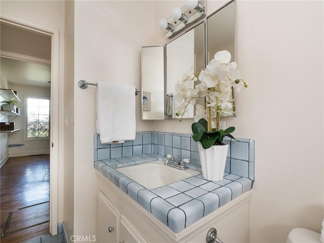 bathroom with hardwood / wood-style floors and vanity