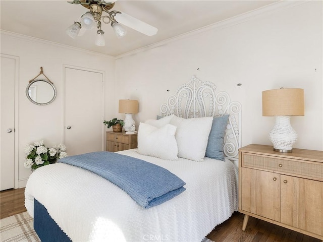 bedroom with ceiling fan, dark hardwood / wood-style flooring, and ornamental molding