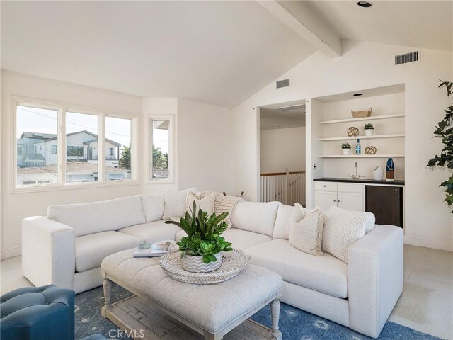 carpeted living room featuring lofted ceiling with beams