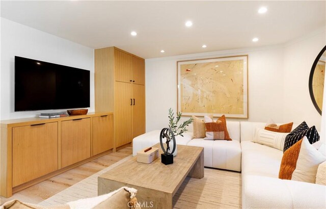 living area featuring light wood-type flooring and recessed lighting