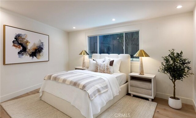 bedroom with recessed lighting, baseboards, and wood finished floors