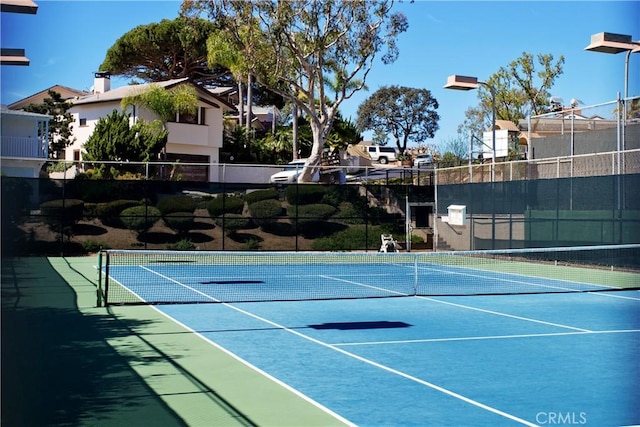 view of tennis court with fence