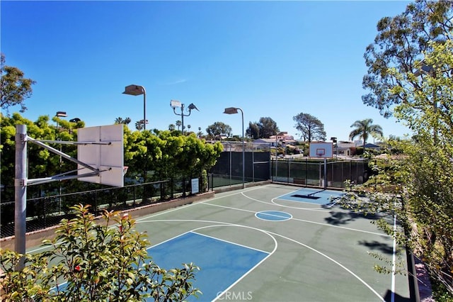 view of basketball court featuring community basketball court and fence