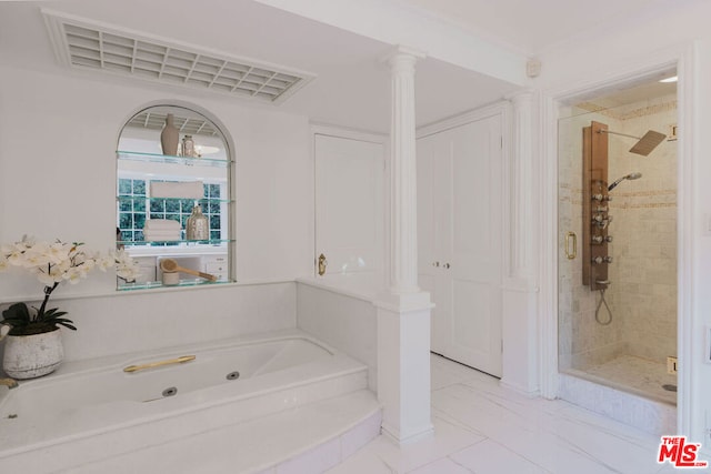 bathroom featuring decorative columns and separate shower and tub