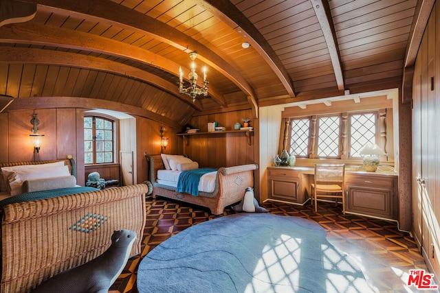 bedroom with dark parquet flooring, wooden walls, lofted ceiling with beams, and an inviting chandelier