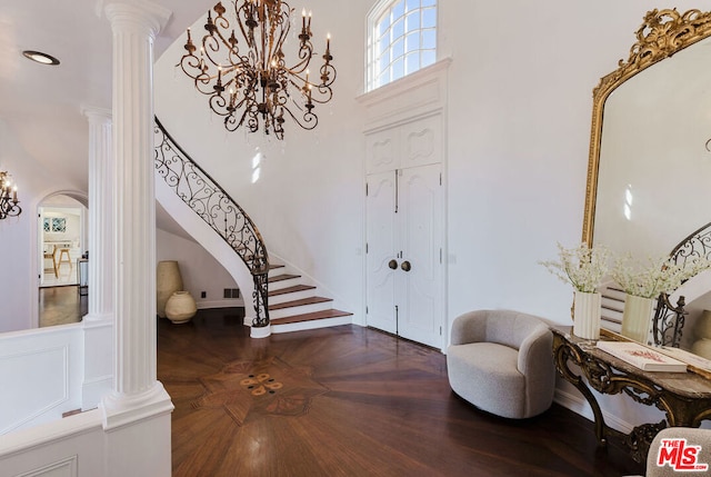 entryway featuring decorative columns and dark hardwood / wood-style floors