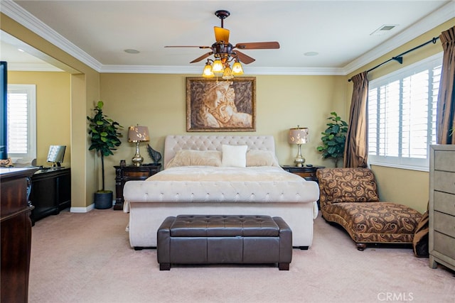 carpeted bedroom with ceiling fan, crown molding, and multiple windows