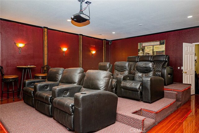 cinema featuring hardwood / wood-style floors and crown molding