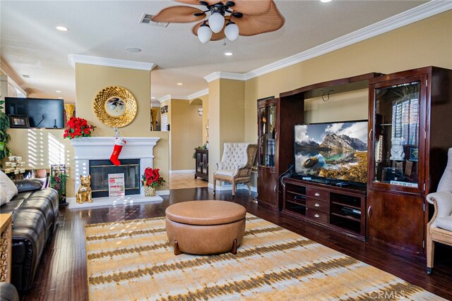 living room with crown molding, ceiling fan, and hardwood / wood-style flooring