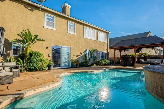 view of pool featuring a gazebo, a patio, and pool water feature