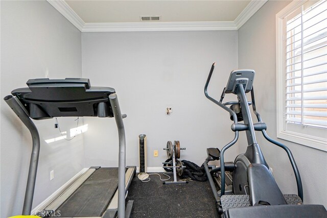 workout room featuring crown molding